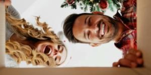 Two people looking into a box happily