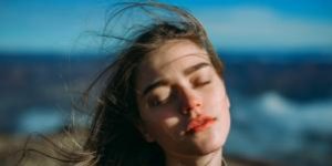 Woman outside with eyes closed